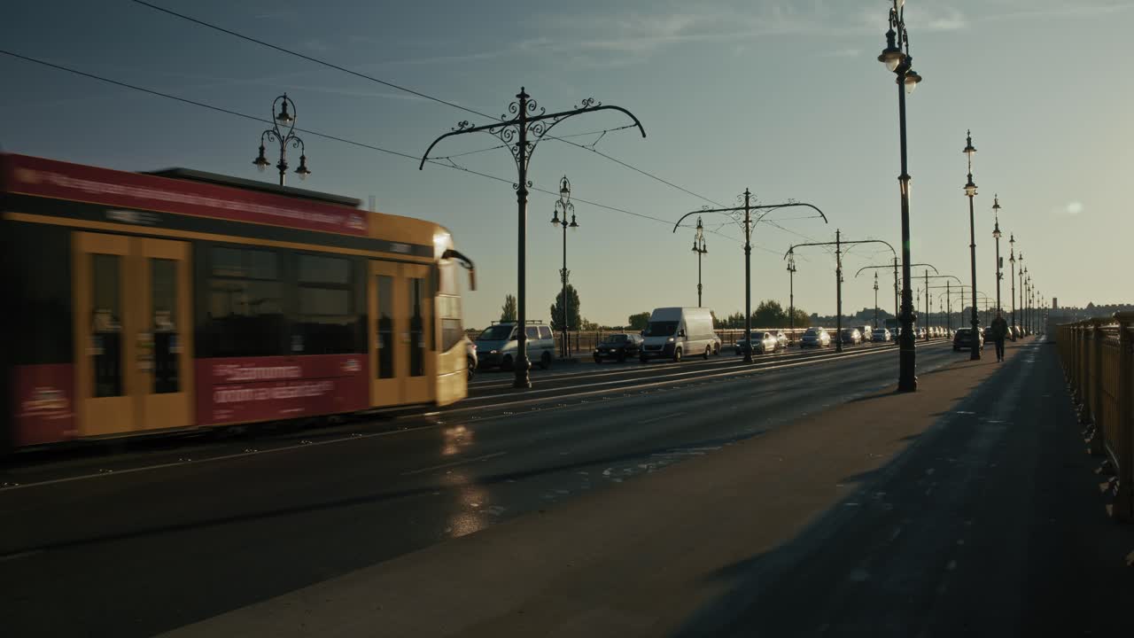 Busy bridge with cars, vans, and a tram moving during sunset, Budapest, Hungary