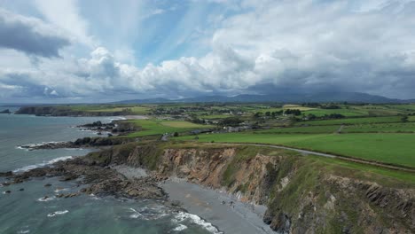 Establishing-shot-Copper-Coast-Waterford-Ireland-storm-clouds-gathering-over-the-Comeragh-Mountains-on-a-warm-July-morning