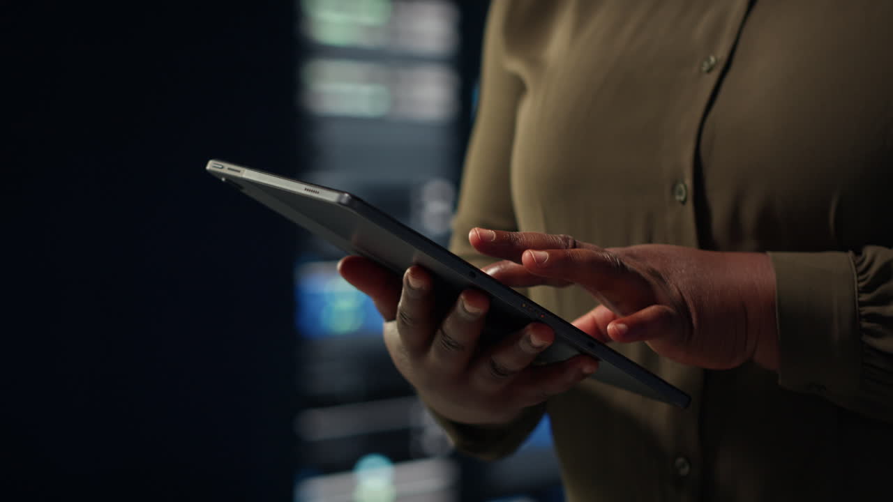Close up shot of admin working in data center using tablet