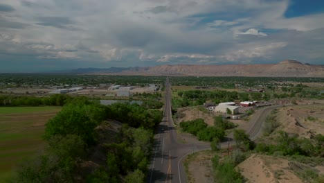 grand junction colorado river aerial drone forward pan up motion summer grand mesa downtown main street afternoon cloudy blue sky wine vineyards parachute fruitvale mt garfield western close delta usa