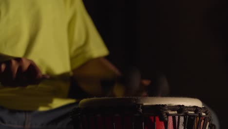 child plays drums with lights flickering on and off.