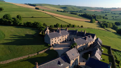 aerial view of a historic farmhouse complex in a rural landscape