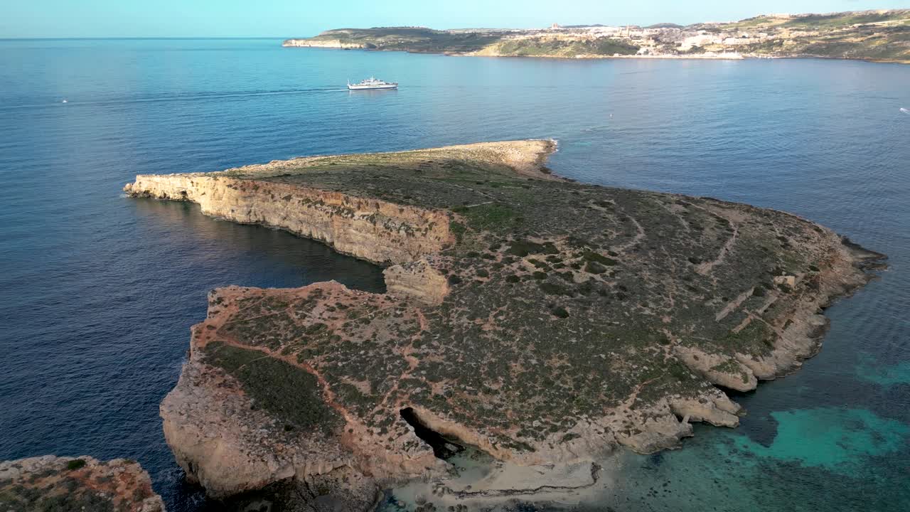 Drone Flying At Comino Island and the Blue Lagoon in Malta, with the Ferry Crossing over to Gozo in the Distance