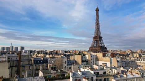 upward aerial movement between the local rooftops and looking to the eiffel tower, paris, france