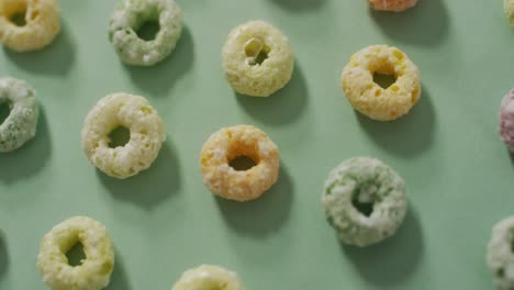 Video-of-colorful-breakfast-round-cereals-on-blue-background