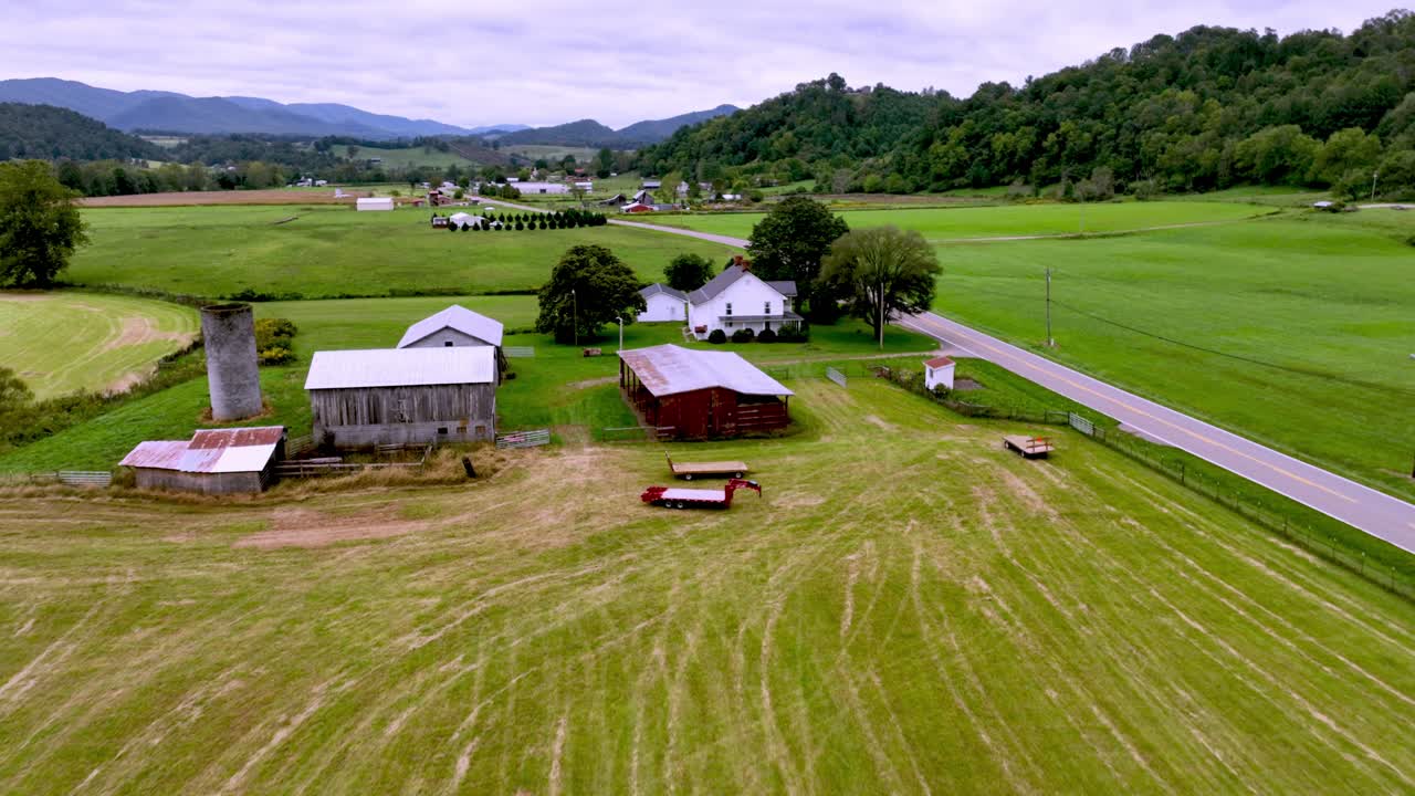 aerial push over farmhouse along roadway near mountain city tennessee