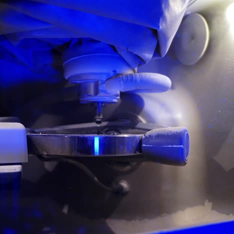professional device in dentistry. automated dental milling machine producing prosthesis implants and artificial human teeth crowns. close-up