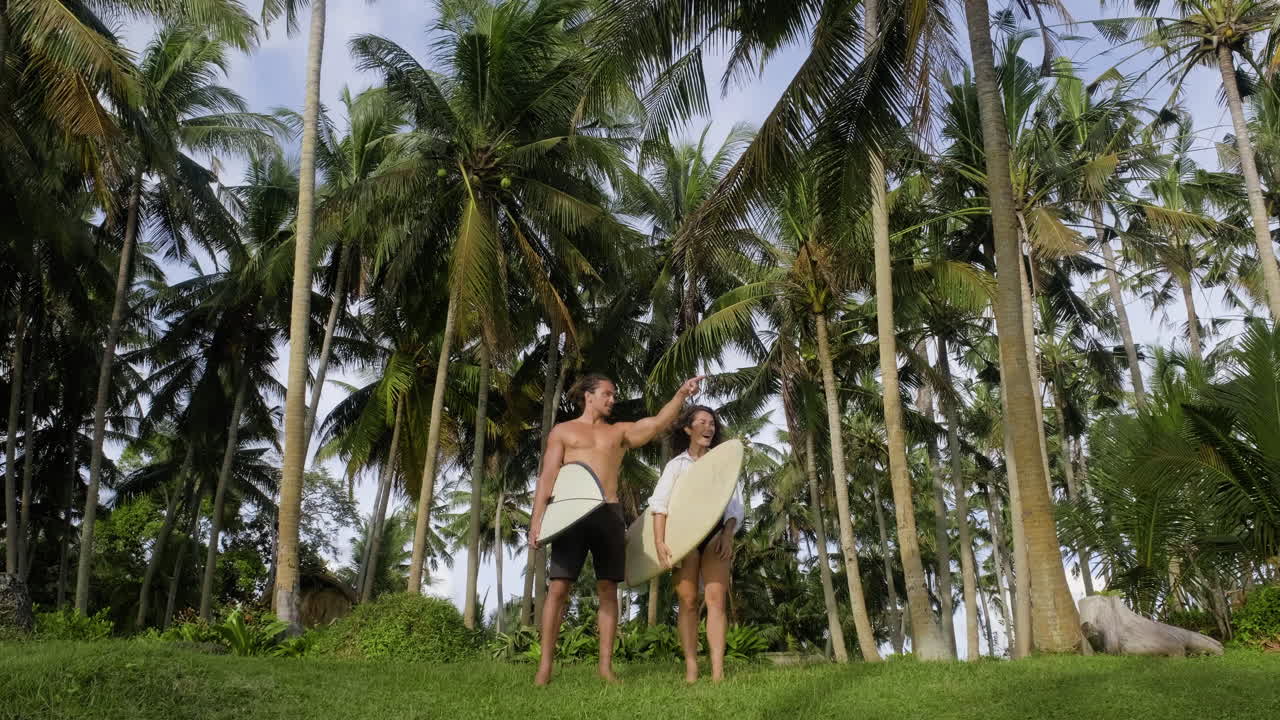 Couple posing with surfboards