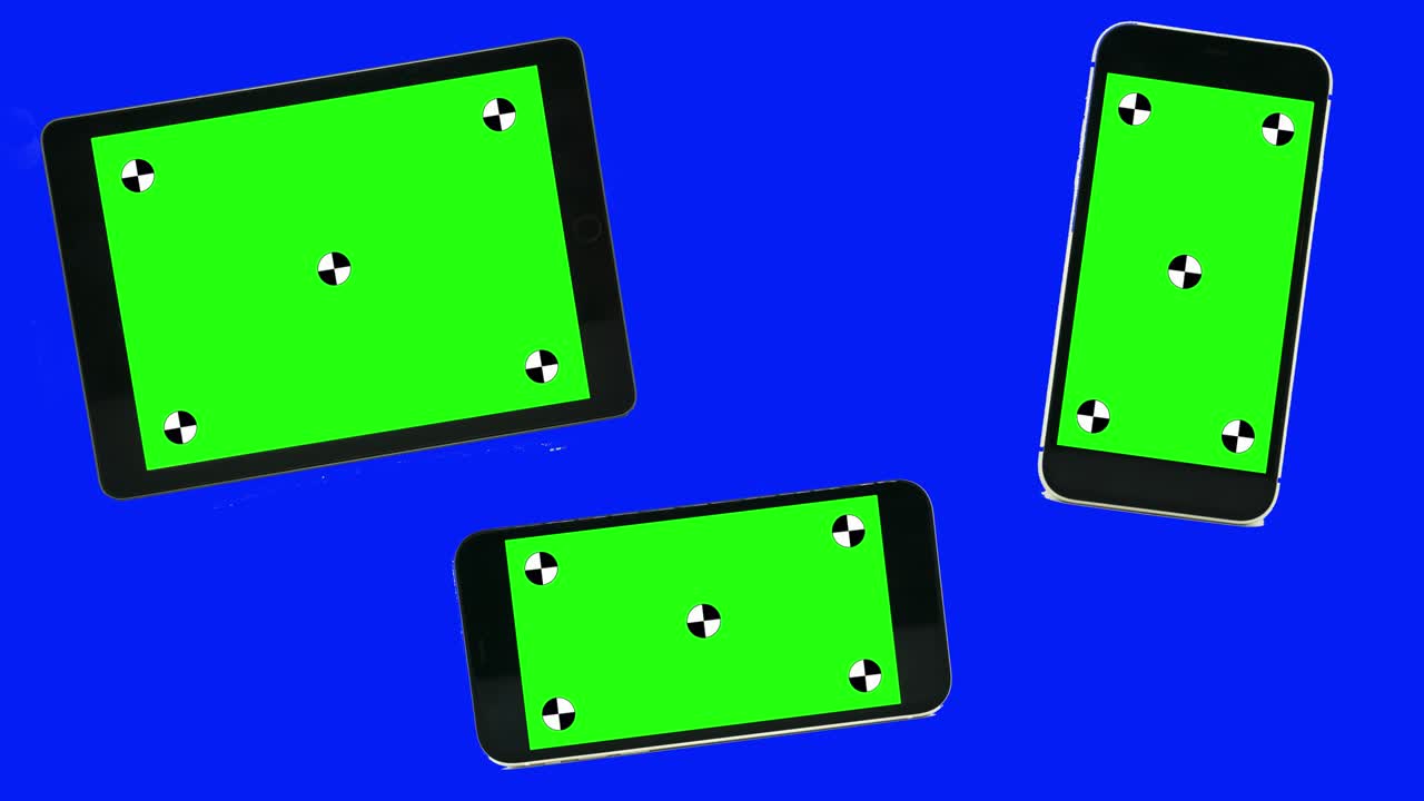 Green screen technology concept. Modern smart phone, tablet and computer mock up with green screen, alpha channel and tracking markers.