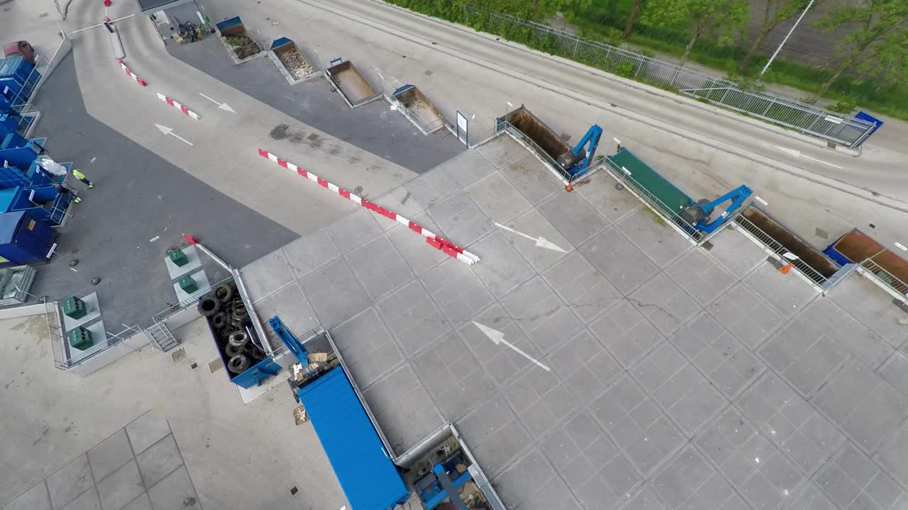 drone volando bajo sobre planta de reciclaje