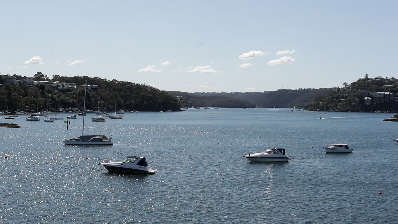 Yachts - sailboats moored in quiet bay, sunny day