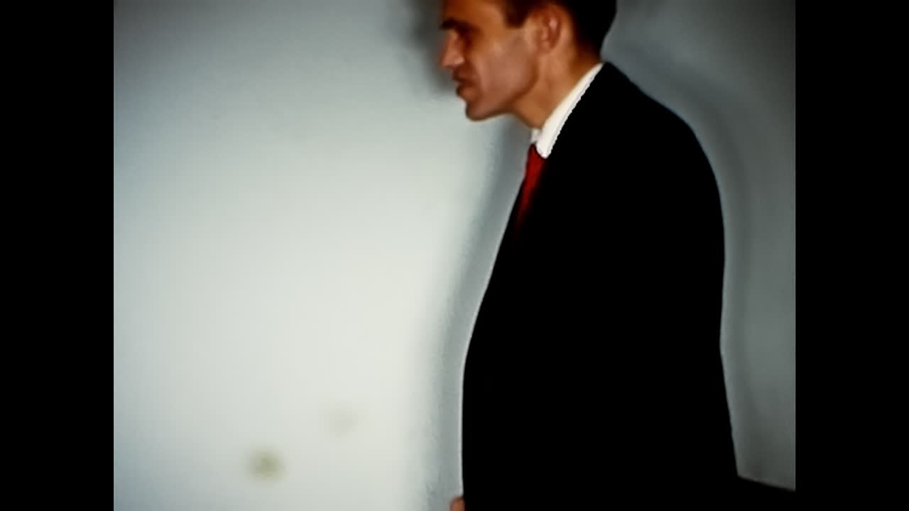 Older and Younger Men Embrace on Couch. CIRCA USA - 1970s: An older man lovingly embraces a younger man on a couch in this 1970s video from the USA.