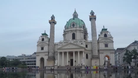 karlskirche (st. charles church) in vienna at dusk and night with reflection