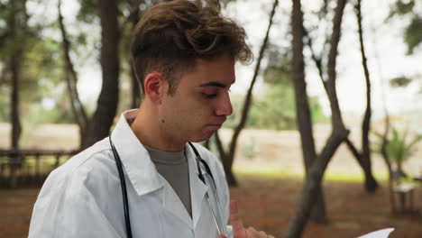 doctor prepares to give bad news about pathology in a park in nature