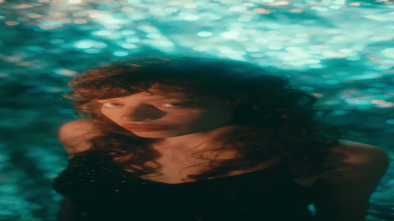 Portrait of Pretty Woman in Sequined Dress against Sparkly Background
