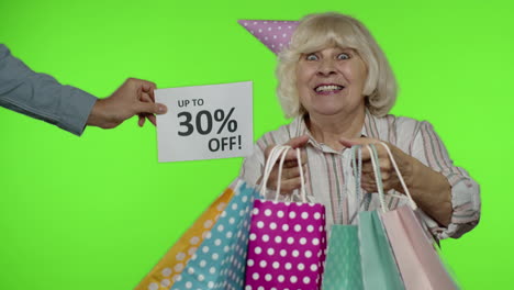 Advertisement-Up-To-30-Percent-Off-appears-next-to-grandmother.-Woman-dancing-with-shopping-bags