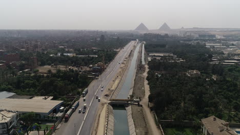 aerial shot for the pyramids of egypt in giza beside the river nile beside