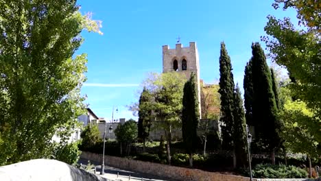 Majestic-establishing-shot-of-San-Juan-Church-tower-from-Tannery-Bridge,-day