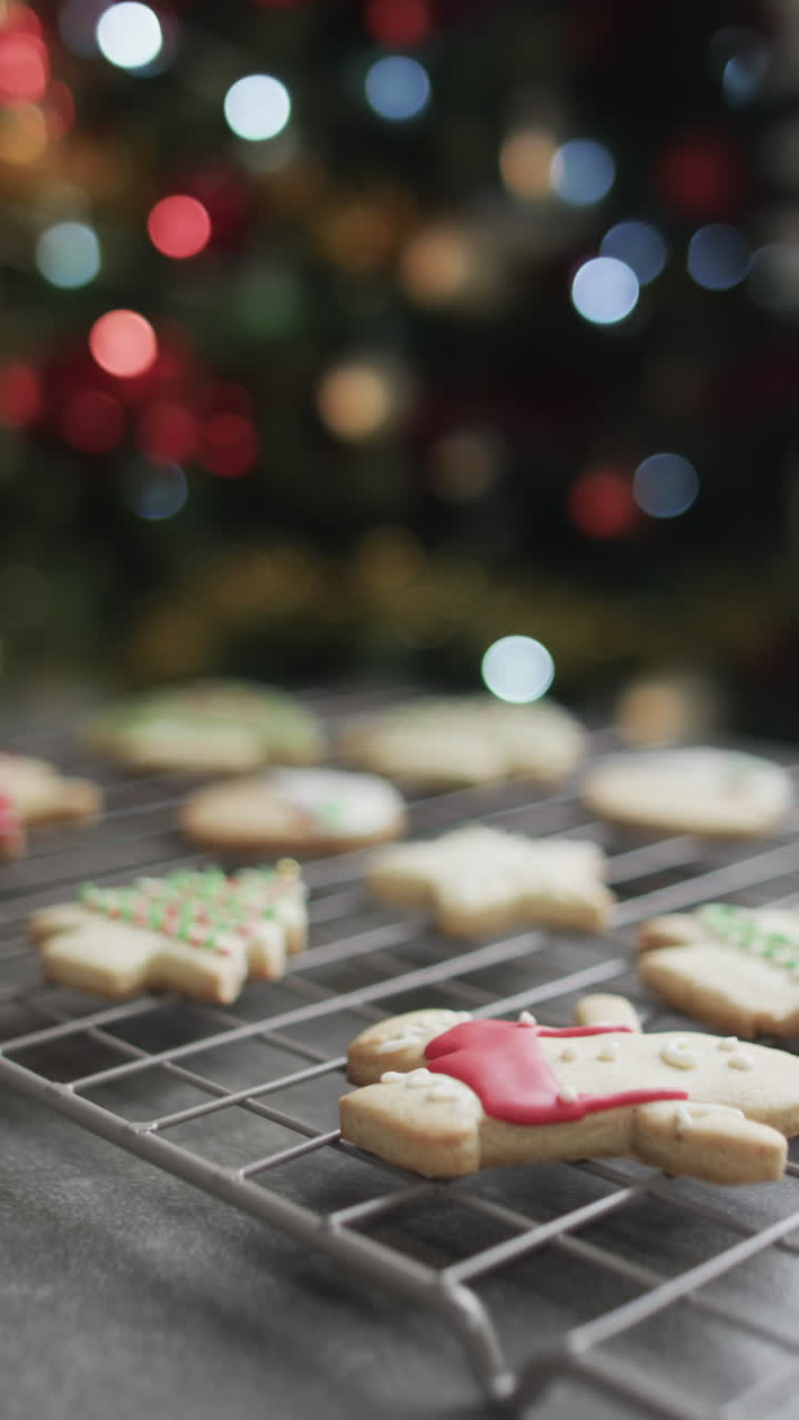 Vertical video of christmas cookies with sugar, chrismtas tree and copy space on black background