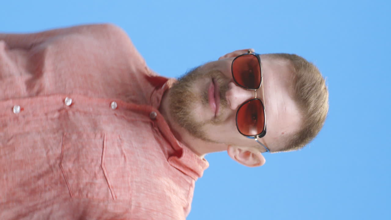 Man in a Coral Shirt with Sunglasses