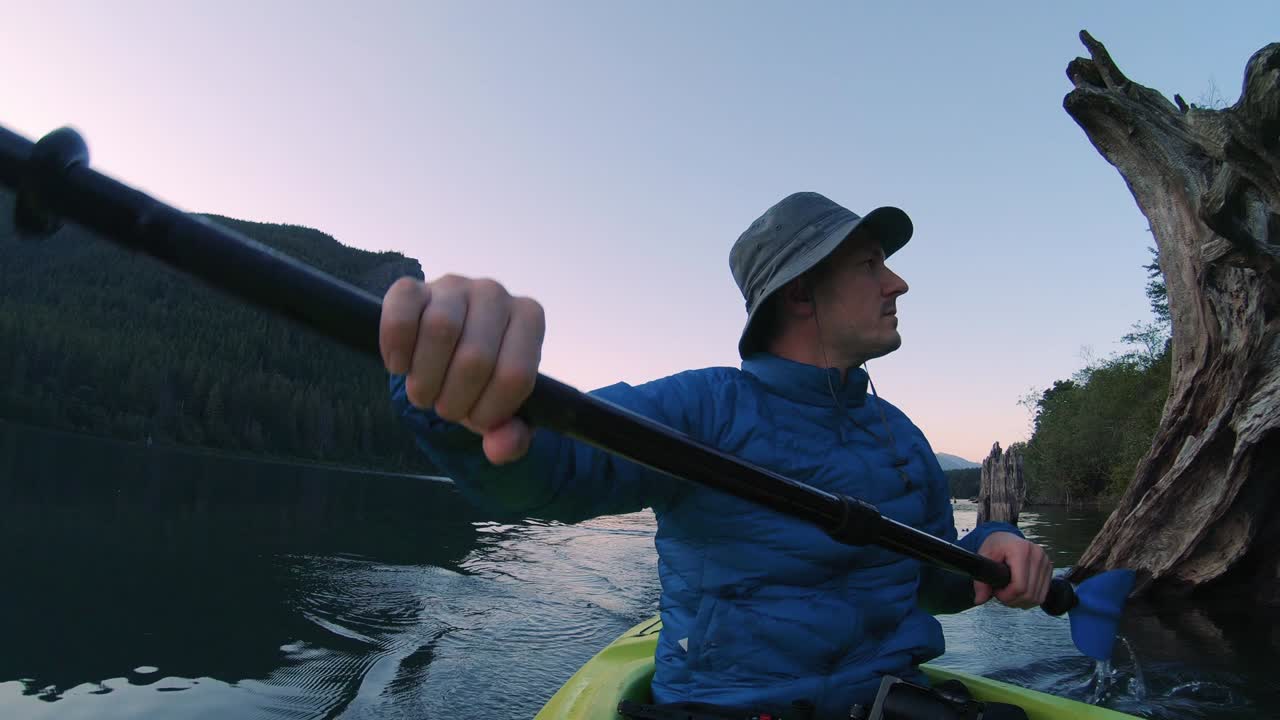 Man Paddling Kayak Slow Motion on Rattlesnake Lake Below Hiking Ledge