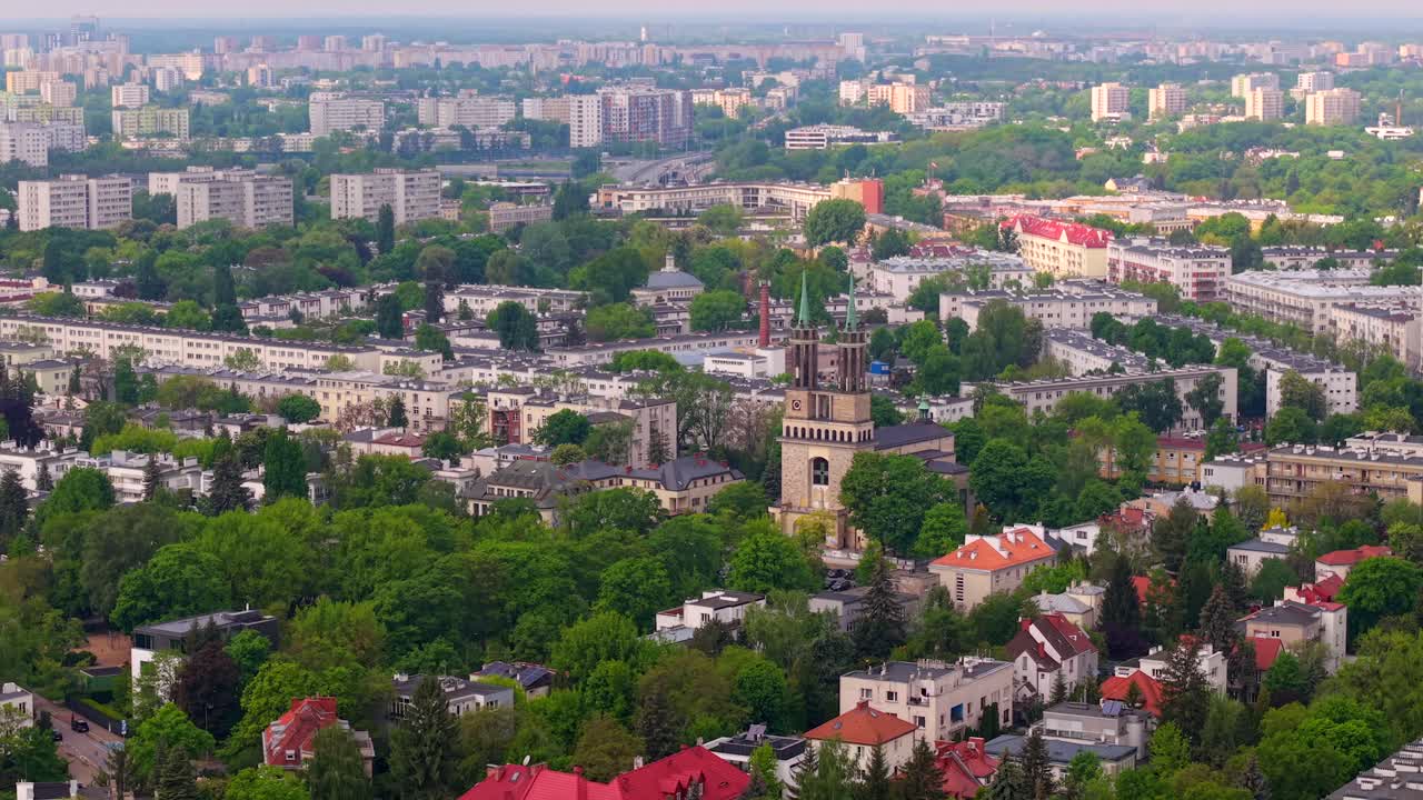 Drone orbits around Saint Stanislaus Kostka Church and Wilson Square in Warsaw, establishing overview