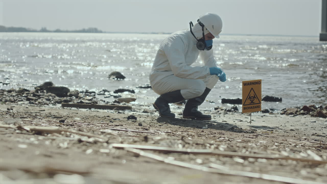 Ecologist in Coveralls Collecting Soil Sample on Gulf Coast