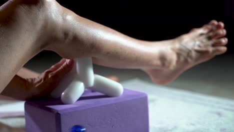 Low-extreme-closeup-view-of-mature-woman-using-a-massage-tool-for-myofascial-therapy-on-her-leg’s-calf