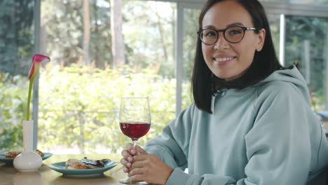 woman enjoying a glass of wine at a restaurant