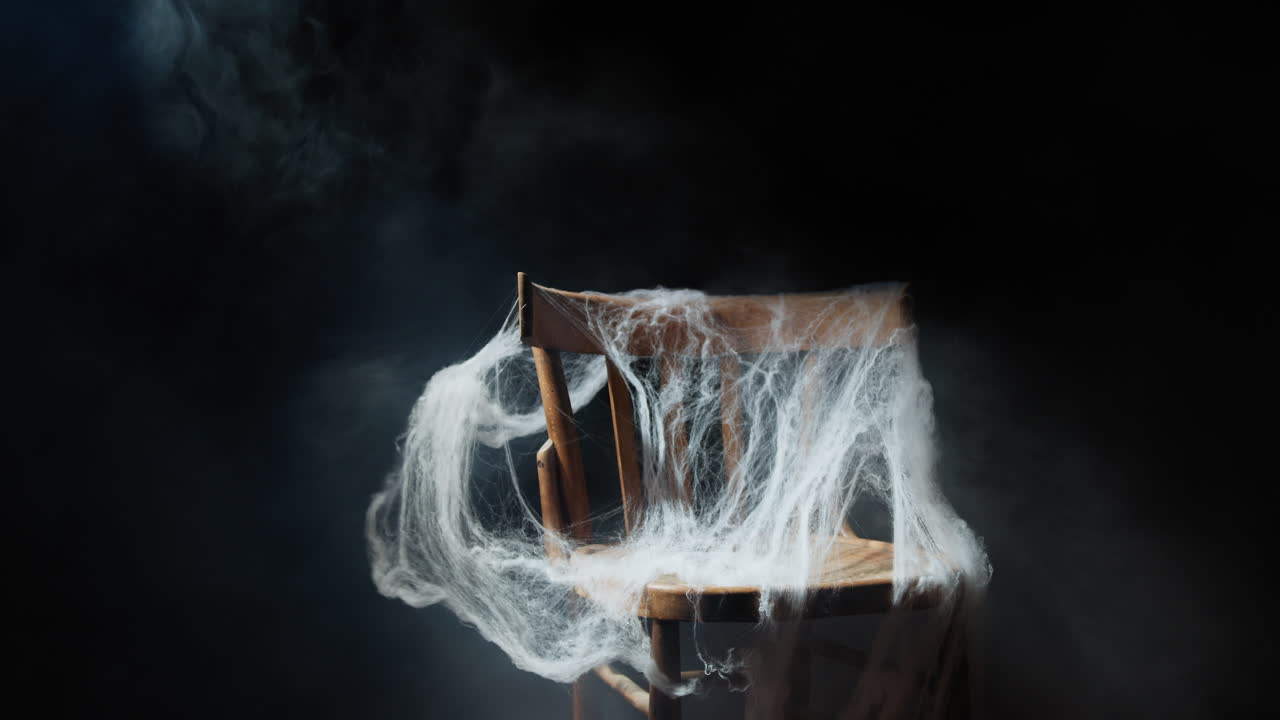 Wooden chair with scary Halloween spiderweb
