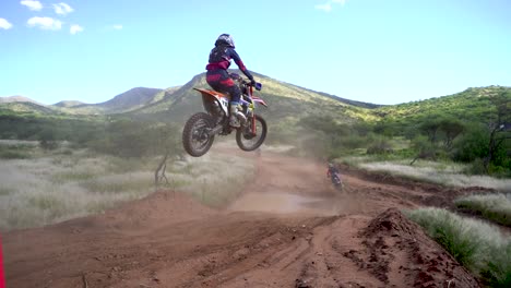 motocross dirt bike riders landing after a jump