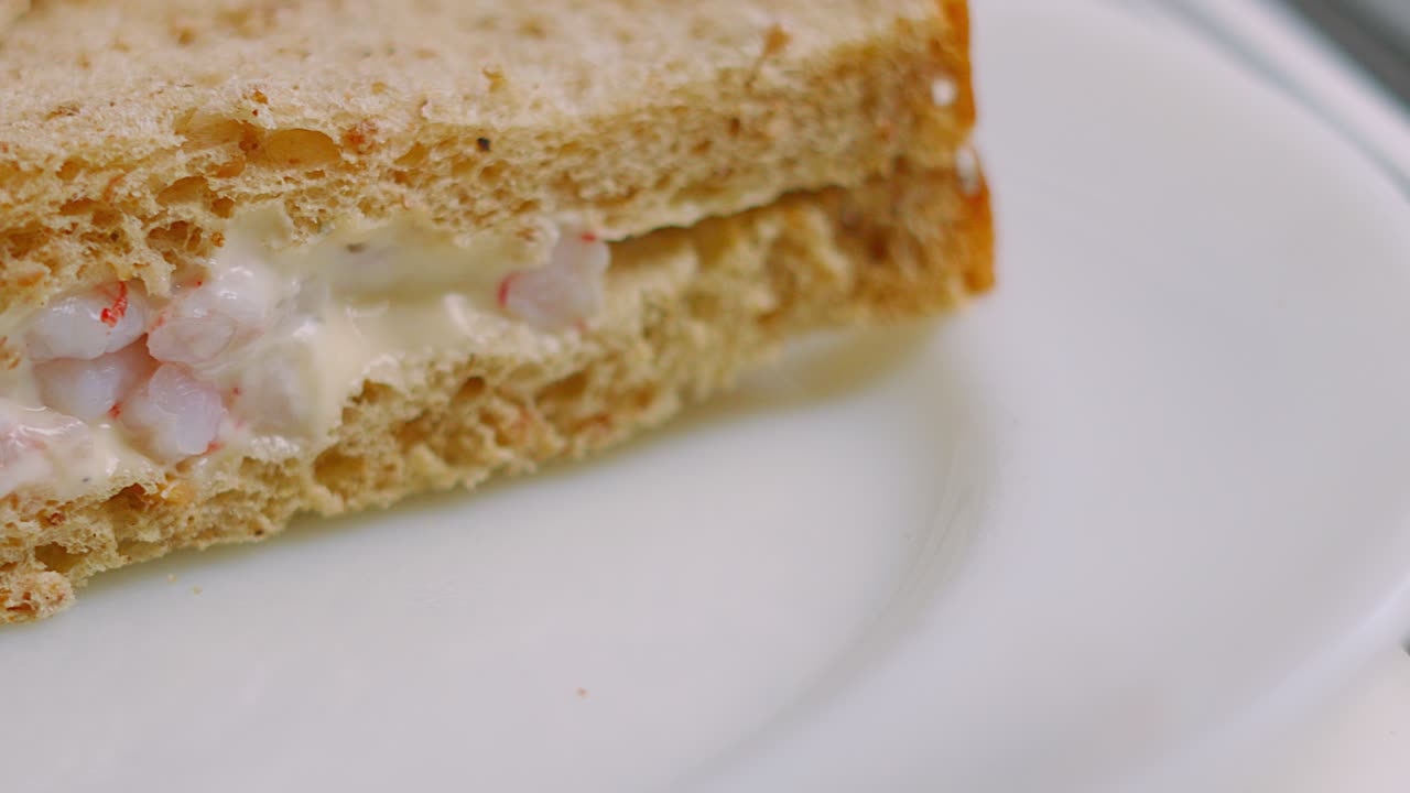 Close Up of Prawn Shrimp Sandwich Stacked on White Plate Ready to Eat for Lunch or Snack. Seafood with Marie Rose Sauce Between Slices of Bread