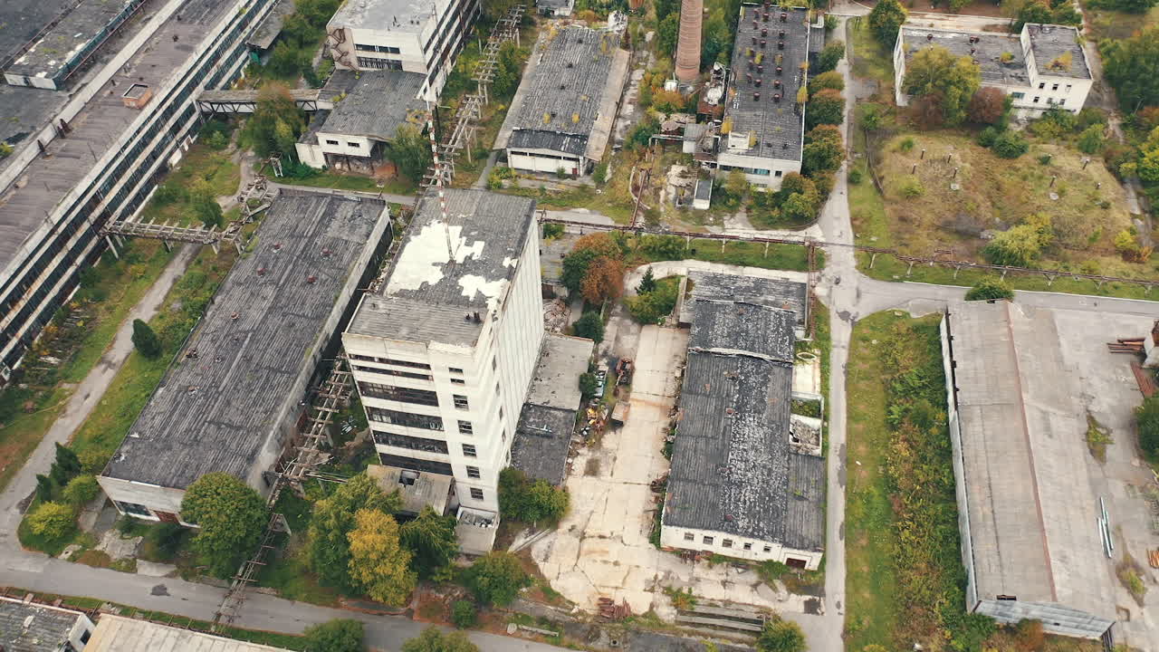 Aerial view of industrial destroyed city buildings. View from above of ruined and abandoned factory.