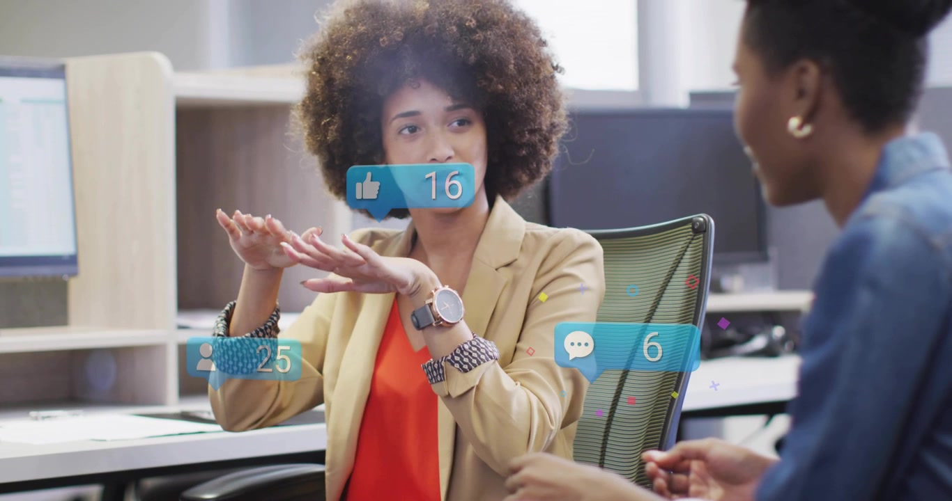 Lead speaker raising hands in office, generating marketing metrics with reaction badges around her