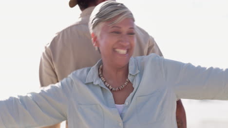 Happy,-dance-and-smile-with-old-couple-at-beach