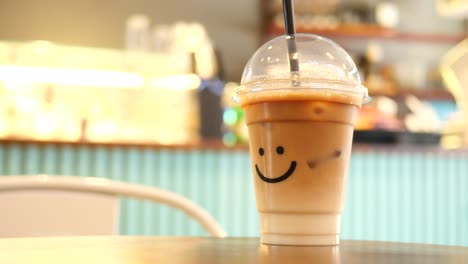 iced coffee in plastic cup with smile