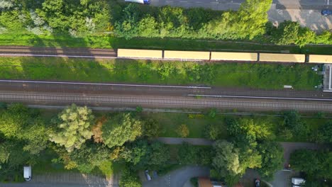 nice aerial top view flight yellow suburban train s-bahn on tracks, berlin marzahn summer 2023