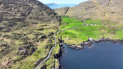 Drone-landscape-winding-lane-between-the-mountains-and-the-sea,Cods-Head-Drive,West-Cork-Ireland,-wold-beautiful-countryside-and-deep-blue-seas