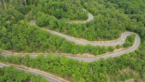 an rv driving down a steep mountain road with numerous hairpin bends