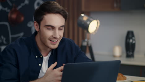 portrait of cheerful business man making video call on computer at home office.