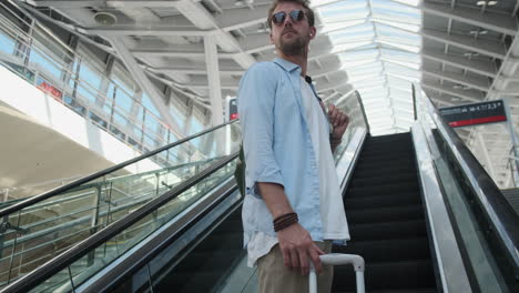 man on an airport escalator