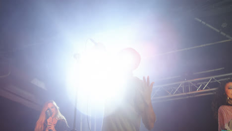 singers performing on stage at a concert 4k