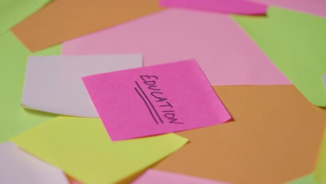 education concept of revolving sticky notes with education written on top note 1