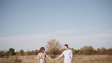 Couple-Hugging-And-Walking-On-A-Meadow-In-Summer-At-Sunset-32