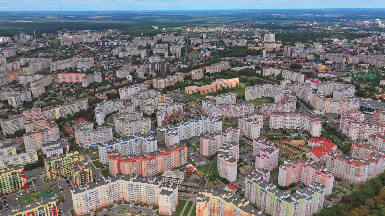 Modern building of residential complex. Aerial drone view over apartment blocks in city. Construction site shot from above. Aerial view of new residential building under construction