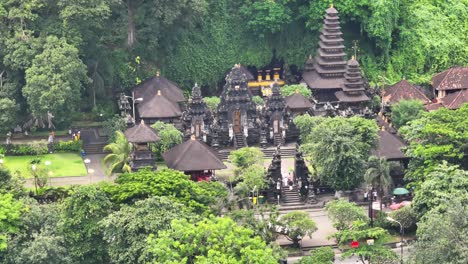 people coming to the sacred temple pray in bali. pura goa lawah, hinduism in indonesia.