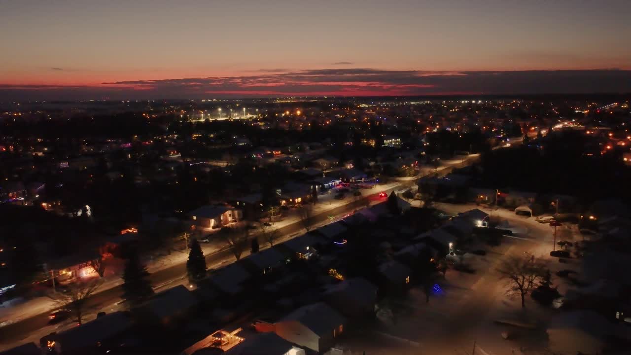 Winter aerial view of St-Constant, Québec, with glowing streetlights at dusk