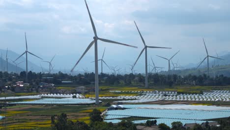 Drone-footage-of-large-electric-windmill-in-a-flat-basin