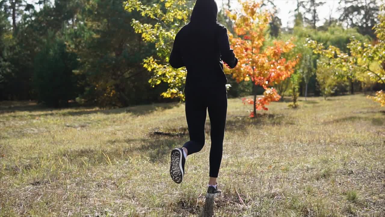 Woman Running in Autumn Forest