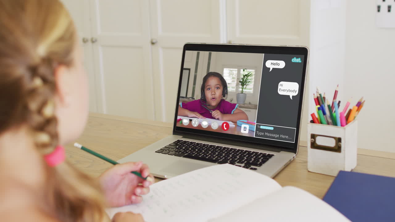 Composite video of girl using laptop for online lesson at home, with diverse schoolgirl on screen